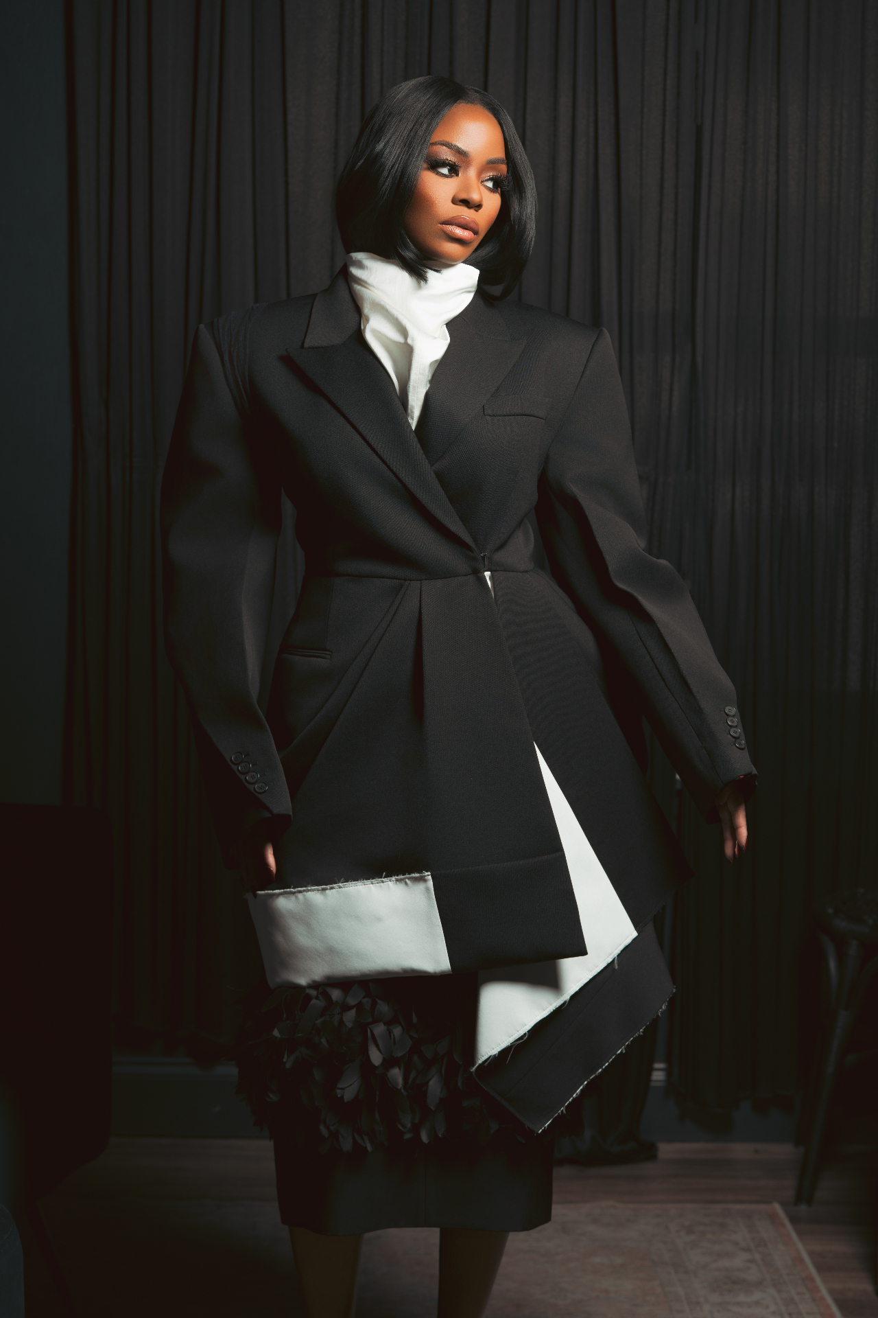 K Stewart client in a sculpted black tailored look